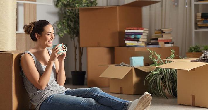 woman sitting with boxes to unpack